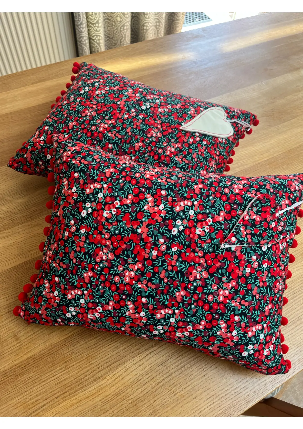 Red cushions with pompoms